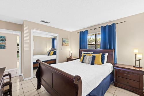 a bedroom with a large bed and a mirror at Edgewater Golf Villa 605 in Panama City Beach