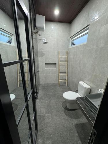 a bathroom with a toilet and a sink at Villa Medea Banyuwangi in Banyuwangi