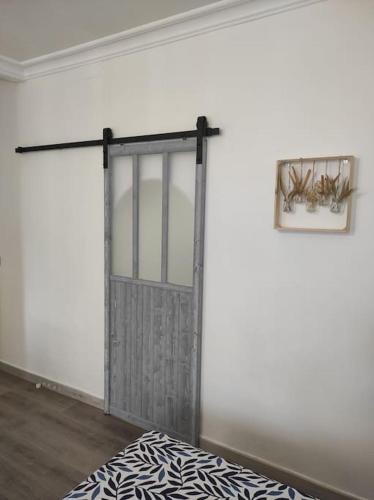 a sliding door in a room with a bed at Studio 28 À l'orée de l'eau in Cloyes-sur-le-Loir