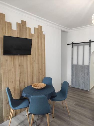 a dining room with a blue table and chairs at Studio 28 À l'orée de l'eau in Cloyes-sur-le-Loir