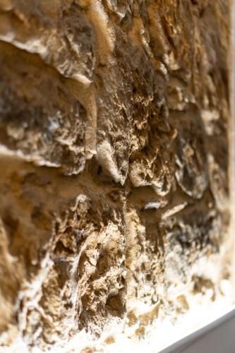 a close up of a stone wall at L'ombelico del Monte - appartamenti in centro storico in Piazza Armerina