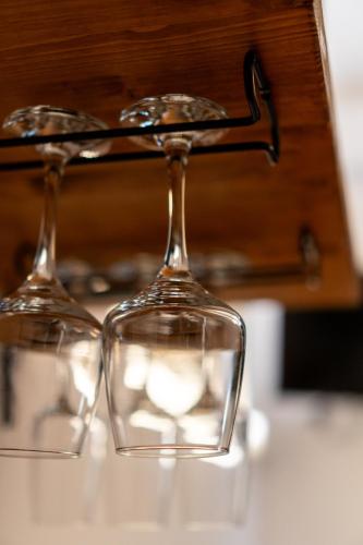 two empty wine glasses sitting on top of a table at L'ombelico del Monte - appartamenti in centro storico in Piazza Armerina