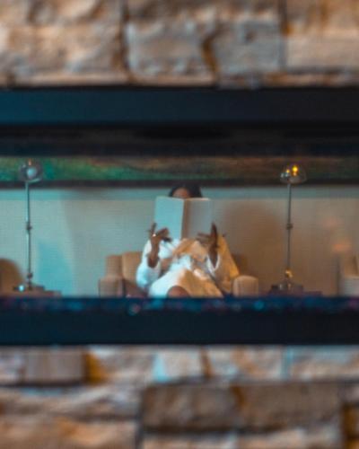 a reflection of a person taking a picture in a mirror at Fairmont Jasper Park Lodge in Jasper