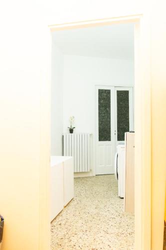 a white room with white counters and a mirror at L'ombelico del Monte - appartamenti in centro storico in Piazza Armerina