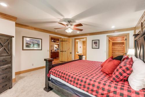 a bedroom with a bed and a ceiling fan at Rogers Cabin on 17 Acres with Wraparound Deck! in Rambo Riviera