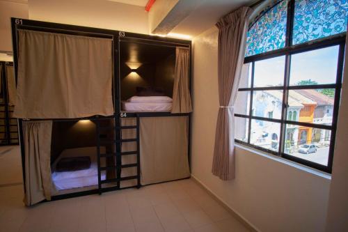 a bunk bed in a room with a window at Some Place Else in George Town