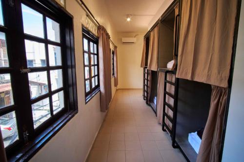 a hallway with two windows and a hallway with a hallwayngth at Some Place Else in George Town