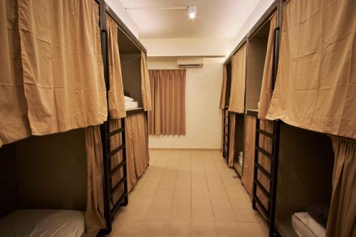 a corridor of a room with bunk beds at Some Place Else in George Town