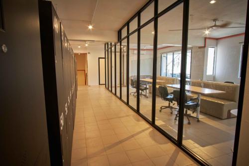 an office with a hallway with a table and chairs at Some Place Else in George Town