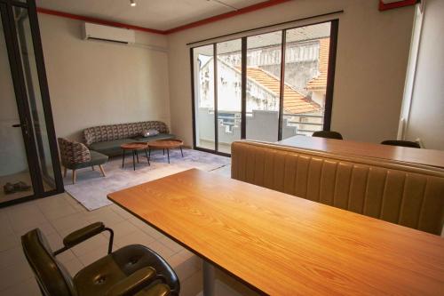 an empty waiting room with a table and chairs at Some Place Else in George Town