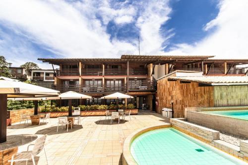 a resort with a swimming pool and a building at Flat Pipa Oceano in Pipa
