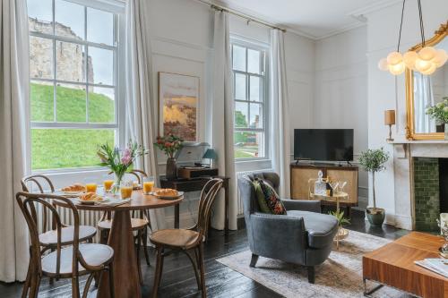 a living room with a table and chairs at Tower View in York