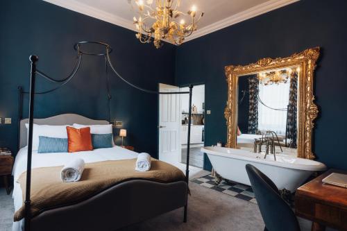 a bedroom with a bed and a tub and a mirror at Tower View in York