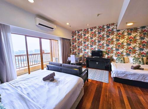 a hotel room with two beds and a balcony at Sunway Studio HomeStay Access Mall & next to Lagoon by Cloud Host in Petaling Jaya