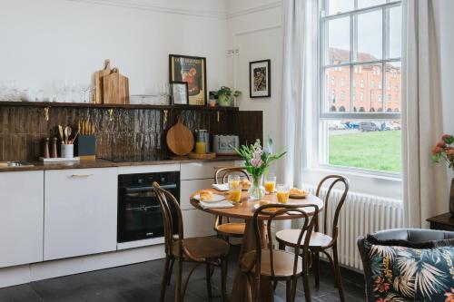a kitchen with a table and chairs and a window at Tower View in York