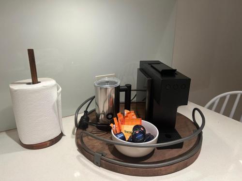 a table with a blender and a bowl of food at Luxury Breeze Beachfront Apartment in Victor Harbor