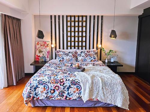 a bedroom with a large bed with a floral bedspread at Sunway Studio HomeStay Access Mall & next to Lagoon by Cloud Host in Petaling Jaya