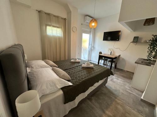 a bedroom with a bed and a table and a desk at Apartment Nika in Starigrad-Paklenica