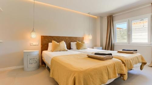 a bedroom with two beds with towels on them at Apartment Alice in Port de Pollensa