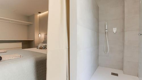 a bathroom with a shower and a bed in a room at Apartment Alice in Port de Pollensa