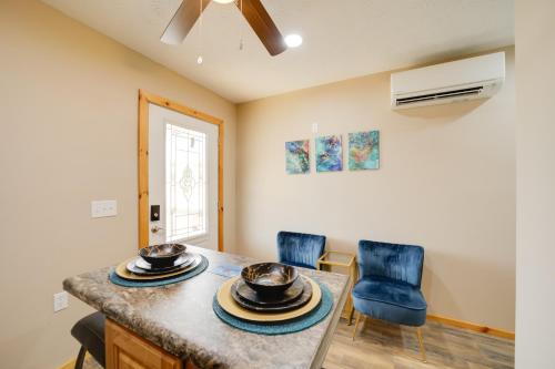 a kitchen with a table and two blue chairs at Cozy Cabin in the Smokies - Great for Couples! in Newport