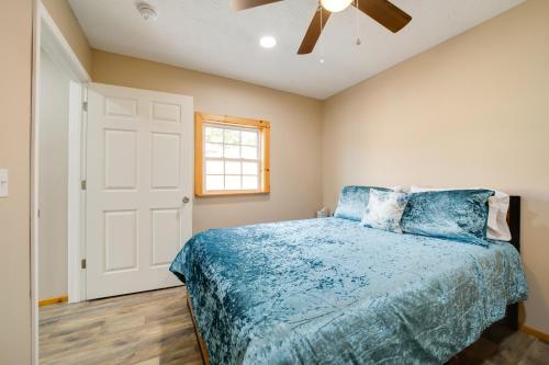 a bedroom with a bed and a ceiling fan at Cozy Cabin in the Smokies - Great for Couples! in Newport
