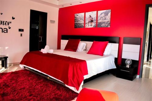 a red bedroom with a large bed with red pillows at Hotel Jade Spa in Santa Rosa de Cabal