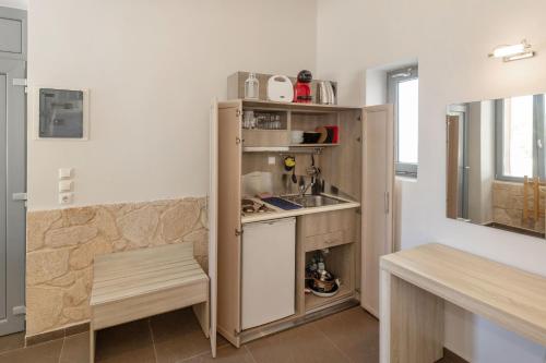 a small kitchen with a sink and a counter at Oinoni's Home - ALEXANDROS studio in Souvala