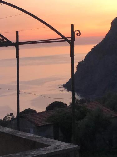 a view of the ocean from a mountain at sunset at Gioiello alle porte delle 5 Terre in Framura
