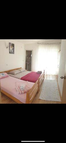a bedroom with two beds and a window at Pipo apartmentS in Ulcinj