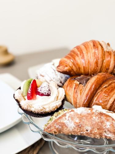 a plate of pastries and croissants on a table at Sentimento Rooftop in Vasanello