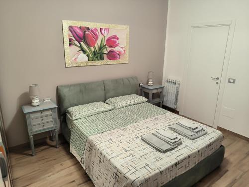 a bedroom with a bed and two night stands at CARLA' S HOUSE in Anzola dell'Emilia