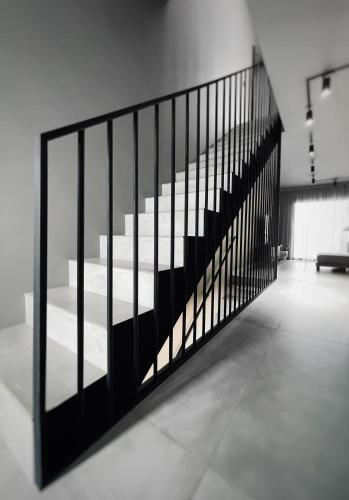 a staircase with black railing in a room at Luxury Beach Villa in Adeje