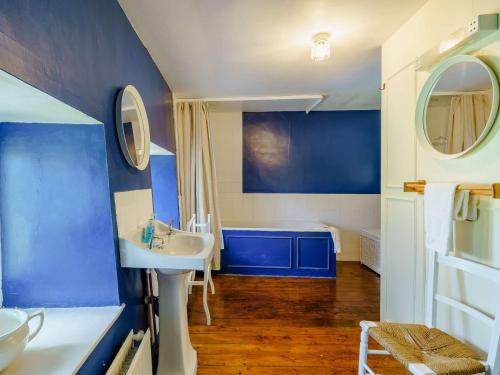 a bathroom with blue walls and a white sink at 5 Bed in Broughton Beck SZ587 in Spark Bridge
