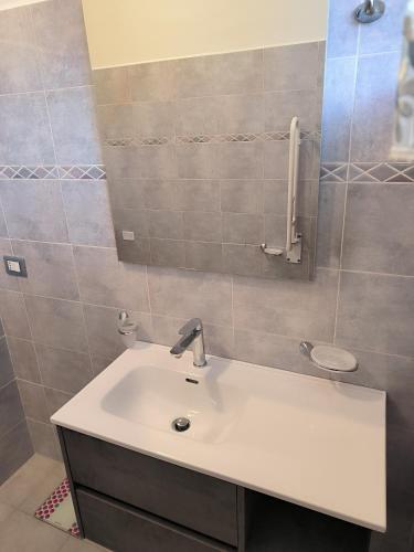 a bathroom with a white sink and a mirror at CARLA' S HOUSE in Anzola dell'Emilia
