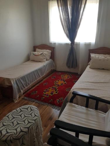 a bedroom with two beds and a window at Beach-Side 2-BR Oasis with Private Pool & Parking in Casablanca