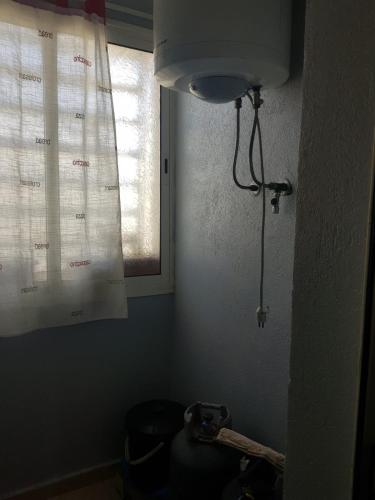 a bathroom with a light and a window in a room at Beach-Side 2-BR Oasis with Private Pool & Parking in Casablanca