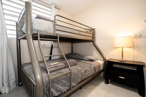 a bedroom with a bunk bed with a ladder at Oasis in the South of the Island with FREE parking and laundry in Ponce