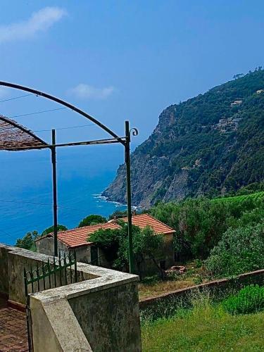 a house on a hill with a view of the ocean at Gioiello alle porte delle 5 Terre in Framura