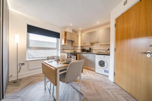 a kitchen with a table and a dining room at Anchor in Basingstoke