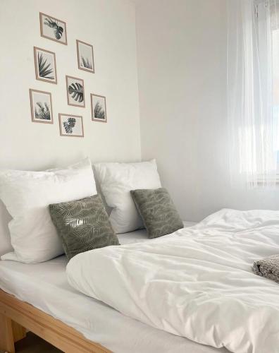 a white bed with white sheets and pillows on it at Domek Na Wzgórzu in Dubiecko