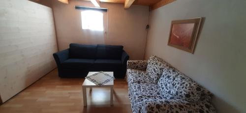 a living room with a couch and a chair at Österlen Vitebro in Sankt Olof