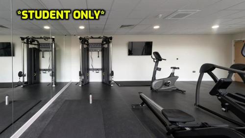 a gym with tread machines and a sign that readsstudent only at Student Only Ensuite Rooms Zeni Bournemouth in Bournemouth