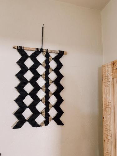 a black and white sweater hanging on a wall at Anza surfhouse in Agadir