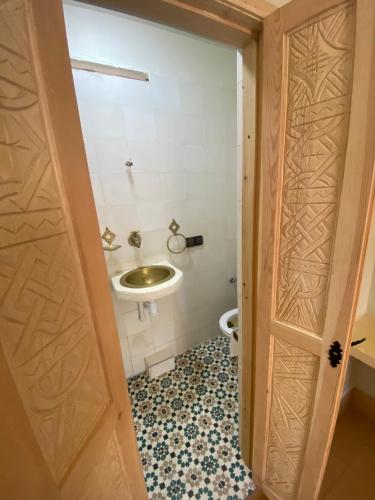 a bathroom with a sink and a toilet at Anza surfhouse in Agadir