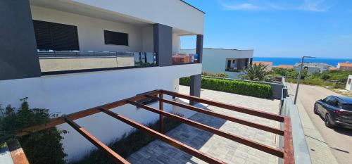 a balcony of a house with a view of the ocean at Villa Primavera in Novalja