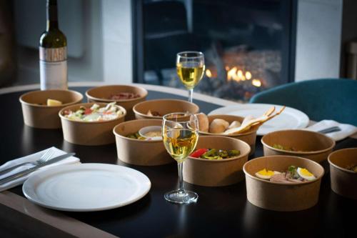 a table with plates and glasses of wine and food at Estérel Resort in Esterel