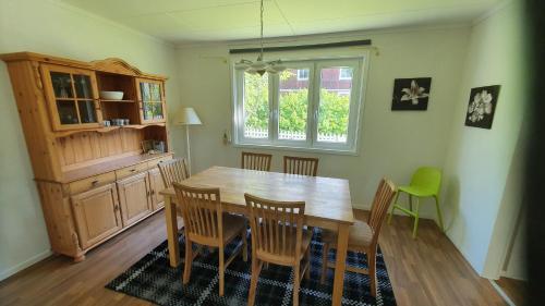 a dining room with a wooden table and chairs at Ferienhaus Lönneberga in Lönneberga