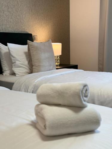 two towels stacked on top of a bed at Penzion 4 pokoje in Prostějov