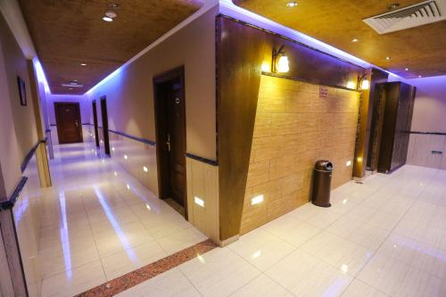 a hallway with a wooden wall in a building at BARADA Hotel- فندق بردى in Qaryat al Bulush